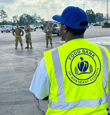 A Food Bank of Northeast Georgia worker wears a yellow reflective vest.